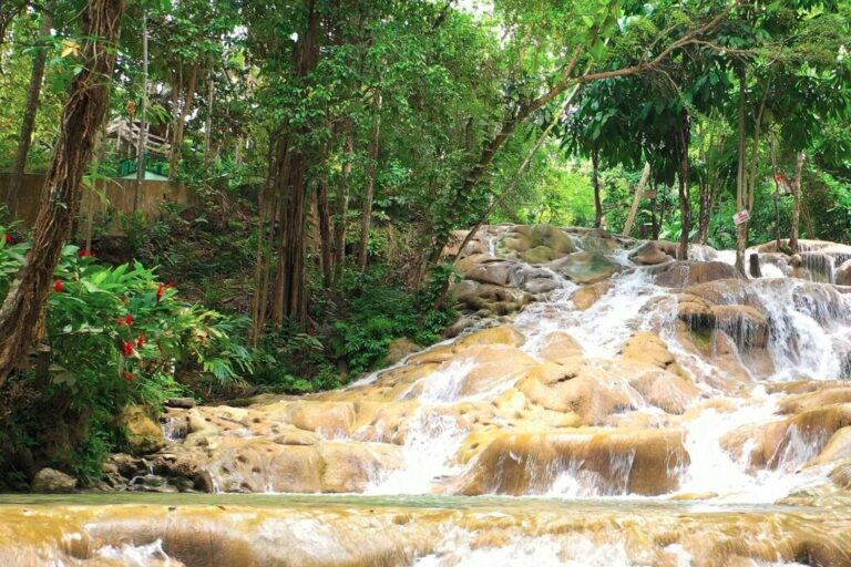 Dunn’s River Falls, one of Jamaica’s most iconic natural landmarks, where terraced limestone cascades flow directly into the Caribbean Sea.