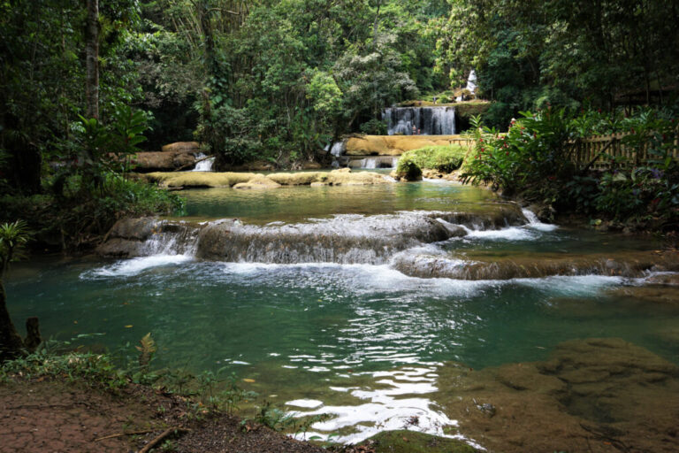 Dunn’s River Falls, one of Jamaica’s most iconic natural landmarks, where terraced limestone cascades flow directly into the Caribbean Sea.
